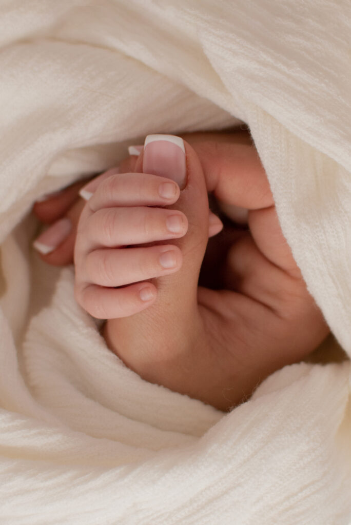 West Sussex Photographer - Elizabeth Cole Photography - newborn hand wrapped around mums thumb