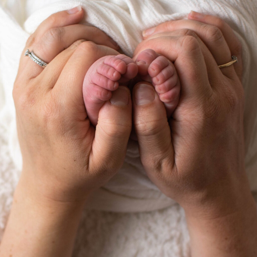 West Sussex Photographer - Elizabeth Cole Photography - newborn toes wrapped around mums hands